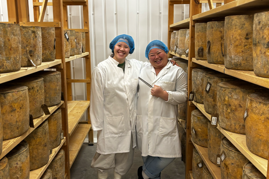 Elyse with cheesemonger trying cheese